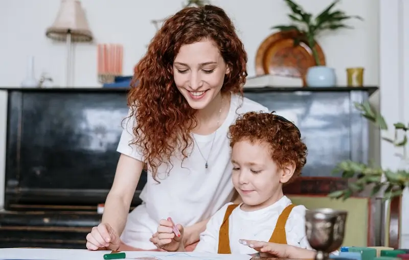 Mother helping son with homework, symbolising the long-term value of independent retirement financial advice across generations.